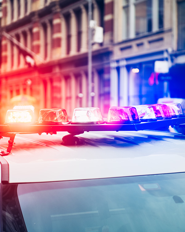 Police Sirens on top of a police car with a big city backdrop